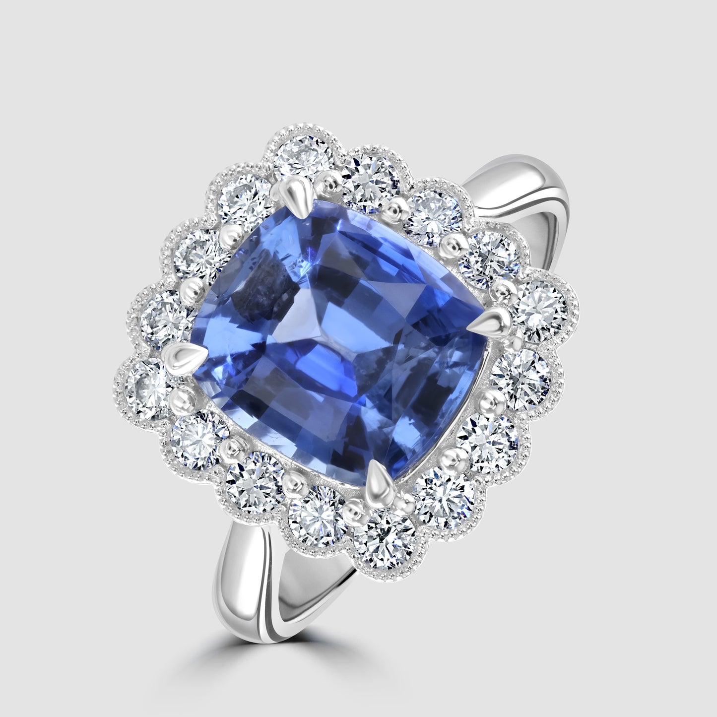 Cushion cut sapphire and diamond cluster ring