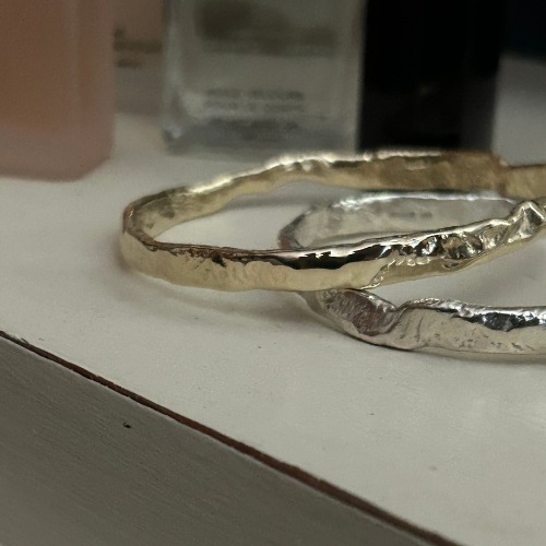 A Luna Textured Gold Bangle from Lulu and Boo Jewellery.