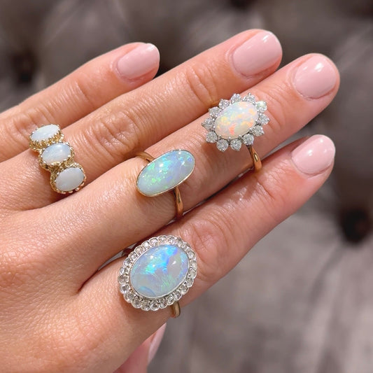 Oval black opal and diamond cluster ring