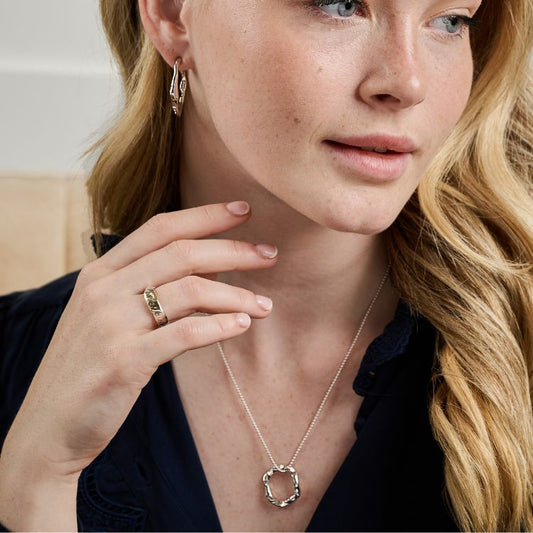 A Luna Sterling Silver Textured Ring and halo pendant and molten earrings from Lulu and Boo Jewellery.
