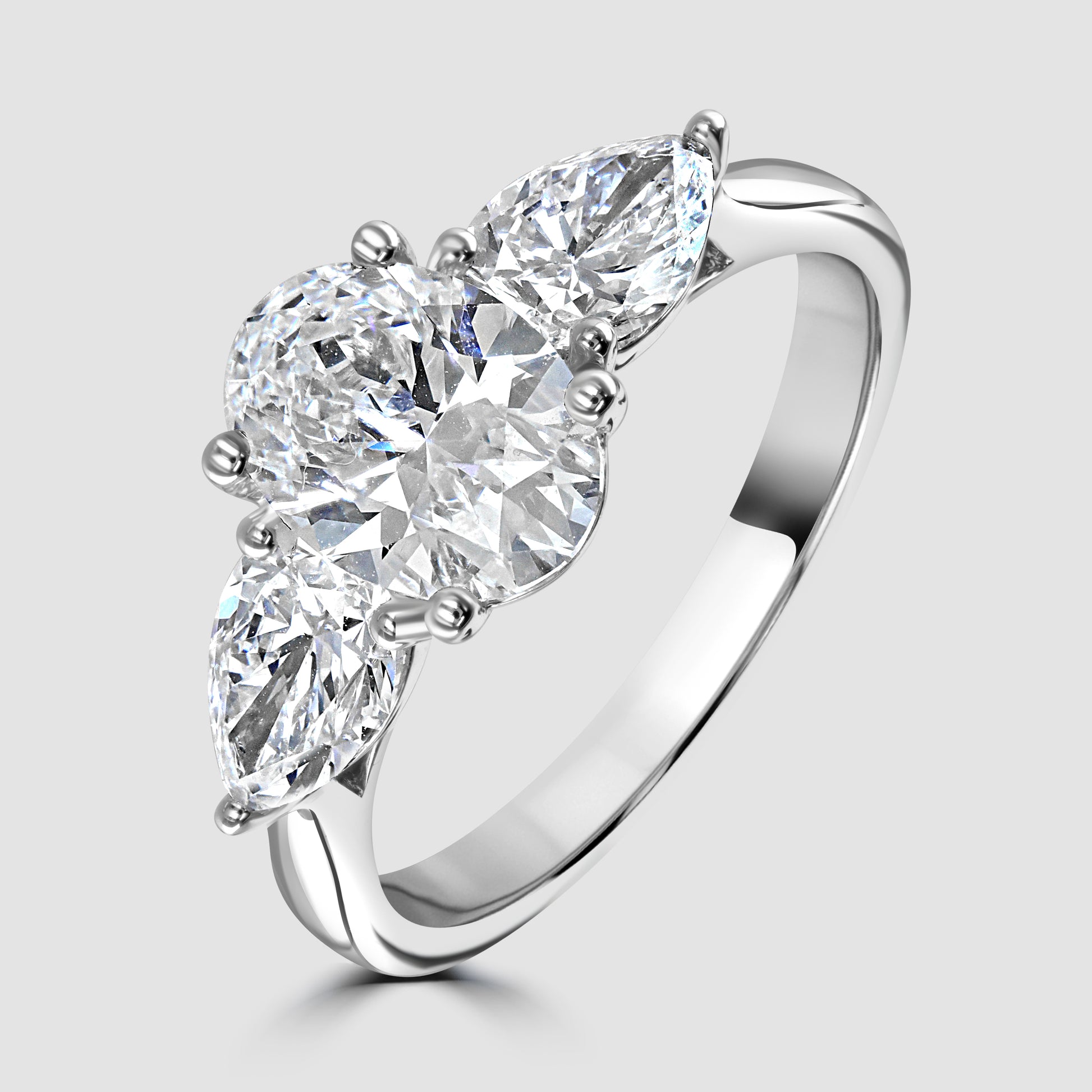 Laboratory diamond three stone oval and pear shape ring 
