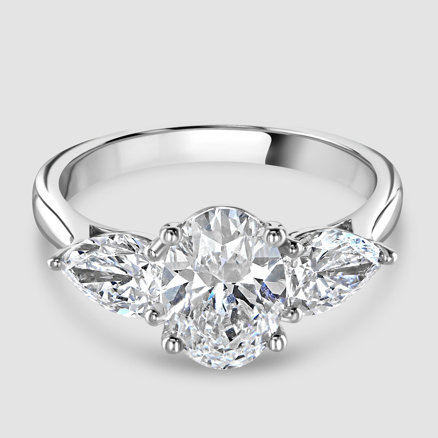 Laboratory diamond three stone oval and pear shape ring 
