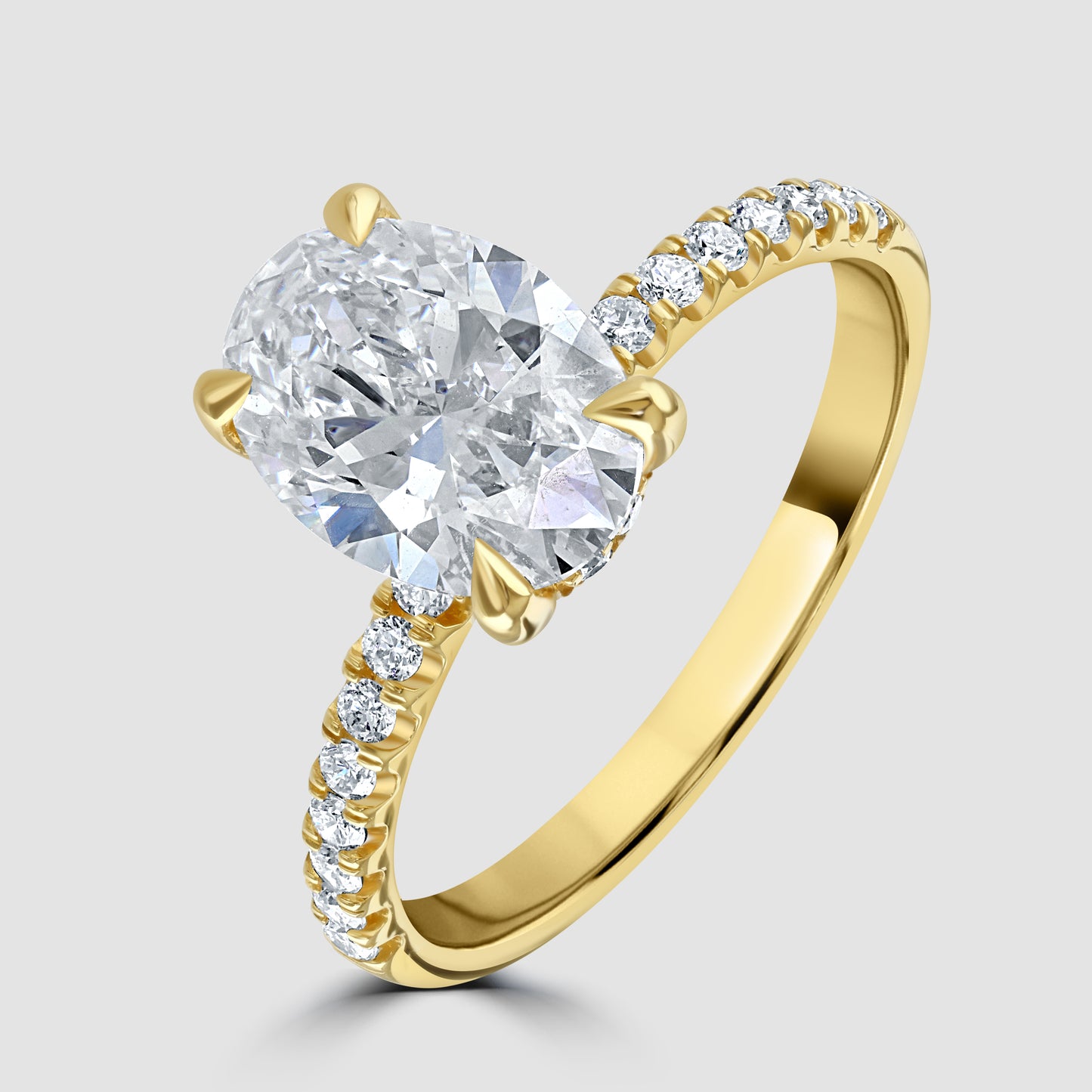 Oval laboratory diamond solitaire with laboratory diamond set shoulders