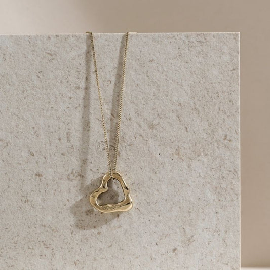 A Molten Heart Small 9ct Gold Necklace from Lulu and Boo Jewellery.