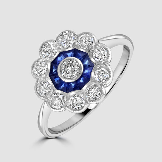 Circular sapphire and diamond cluster ring