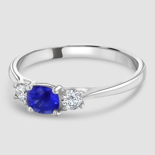 Cushion cut sapphire and diamond three stone ring