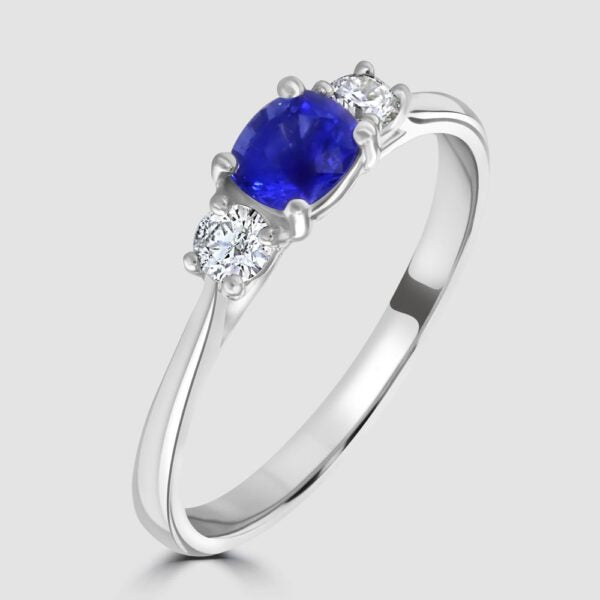 Cushion cut sapphire and diamond three stone ring