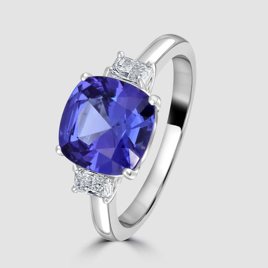 Cushion cut tanzanite and radiant diamond three stone ring