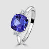 Cushion cut tanzanite and radiant diamond three stone ring