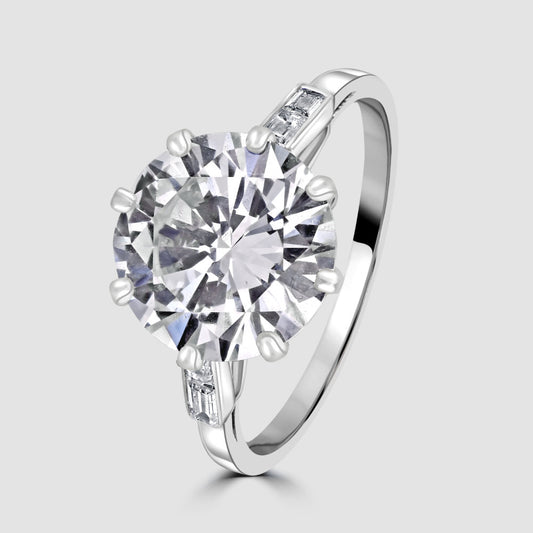 Diamond solitaire ring with baguette shoulders