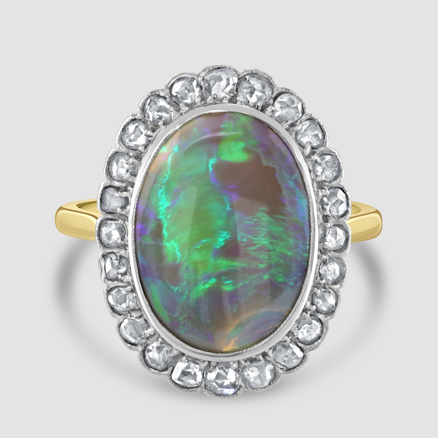 Oval black opal and diamond cluster ring