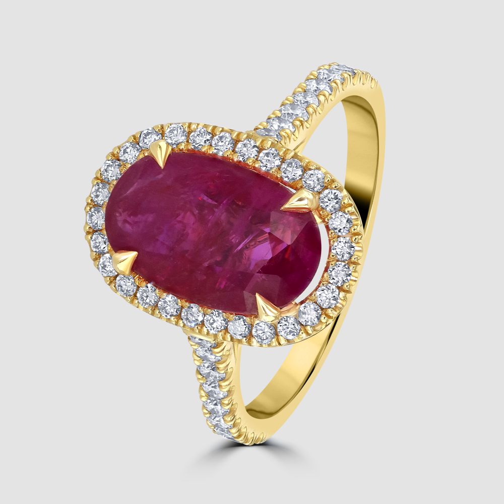 Ruby and diamond oval cluster ring with diamond set shoulders