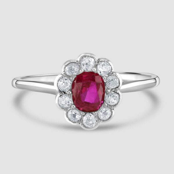 Ruby and diamond oval millgrain edge cluster ring