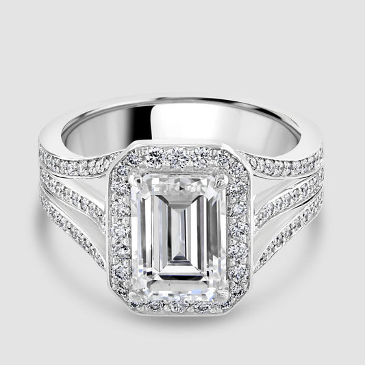 Superb emerald cut diamond with triple split shoulders