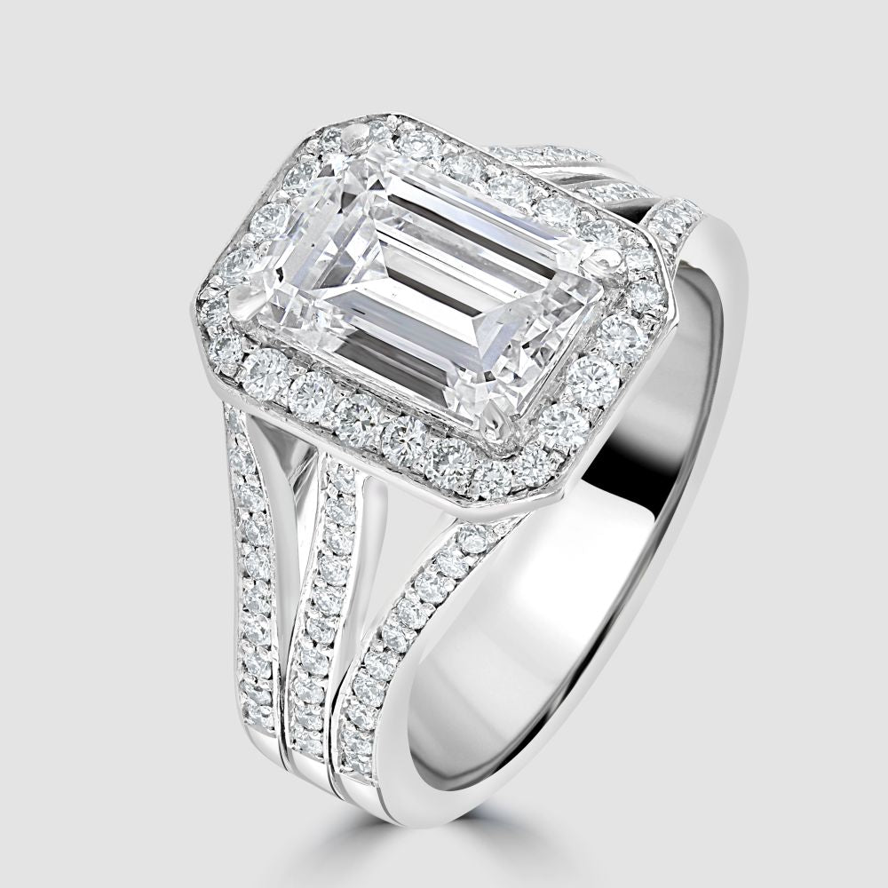 Superb emerald cut diamond with triple split shoulders