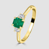 Yellow gold emerald and diamond three stone ring